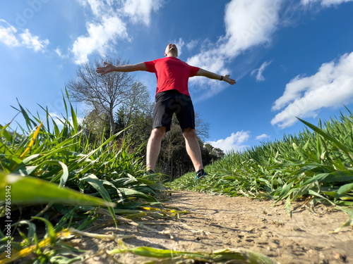 Running Man in full nature with a bottom up view