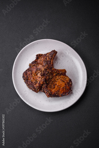 Delicious beef or pork steak on the bone grilled with spices and rosemary