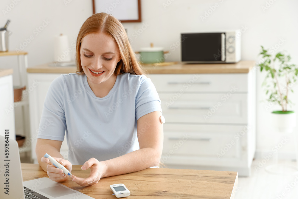 Woman with diabetes measuring blood sugar level at home Woman with diabetes measuring blood sugar level at home