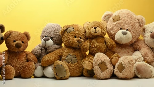 Brown teddy bears sit in a row, camera movement to the right