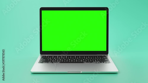 modern laptop with green screen on display for footage placement.