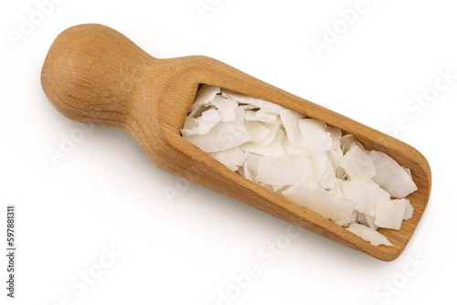 Coconut flakes or chips in wooden scoop isolated on white background. Top view. Flat lay