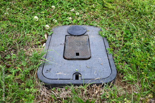 residential water meter in the grass photo