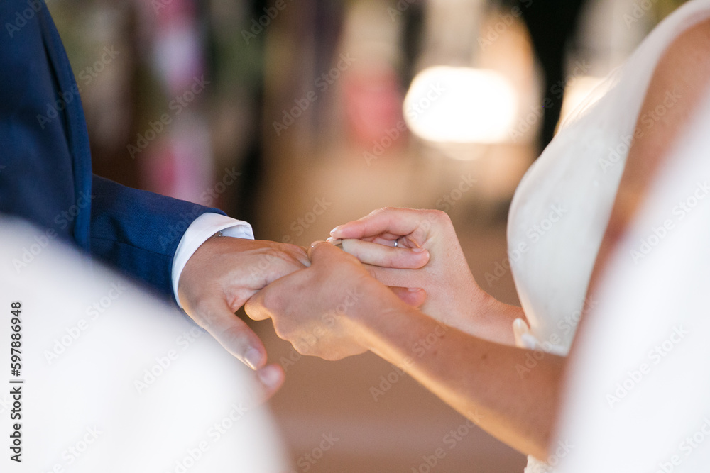 Fototapeta premium Intimate Moment of a couple Exchanging Wedding Rings at a wedding