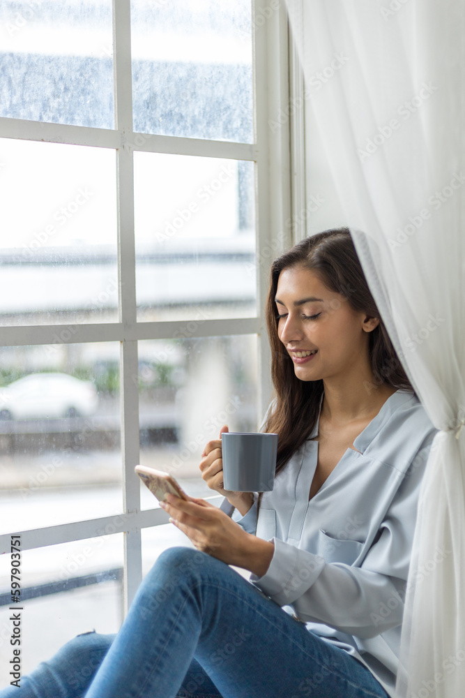 Content Creator Enjoying Coffee and Smartphone by the Window Content Creator Enjoying Coffee and Smartphone by the Window