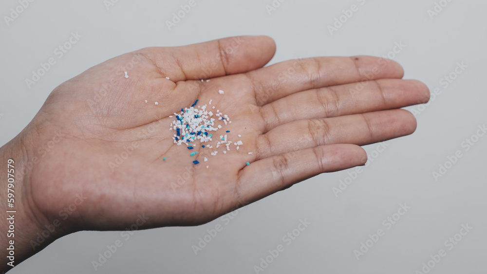 Climate change idea. Close up microplastics lay on female people finger hand. it's very small. Climate change idea. Close up microplastics lay on female people finger hand. it's very small.