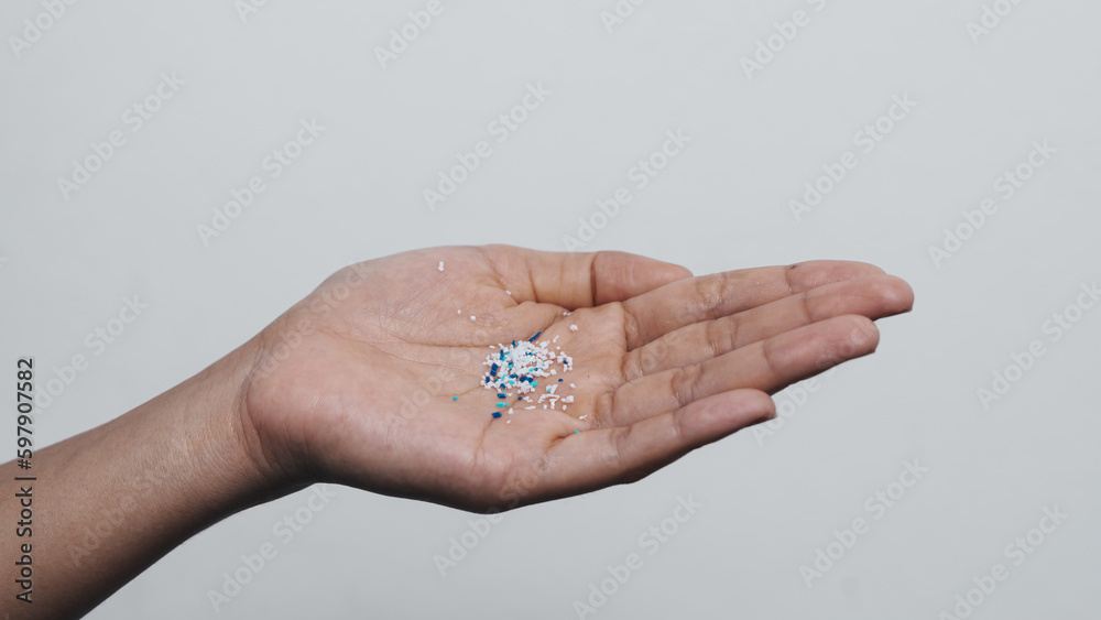 Climate change idea. Close up microplastics lay on female people finger hand. it's very small. Climate change idea. Close up microplastics lay on female people finger hand. it's very small.