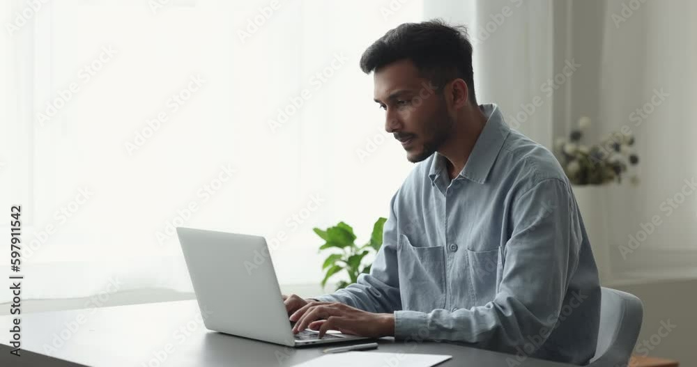 Indian businessman typing on laptop keyboard seated at workplace desk in office, side view. Pensive, thoughtful freelancer solve business, lead chat, correspond to client remotely Generative AI Indian businessman typing on laptop keyboard seated at workplace desk in office, side view. Pensive, thoughtful freelancer solve business, lead chat, correspond to client remotely Generative AI