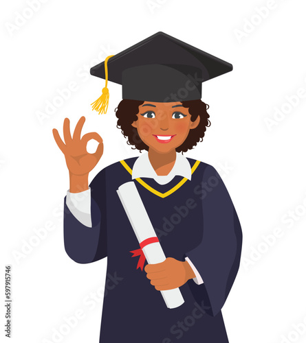 Happy young graduate African woman in graduation gown and hat holding diploma and certificate showing okay gesture