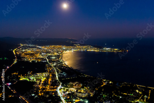 Gelendzhik, Russia. View of the night city, bay and moon. Summer. Aerial view