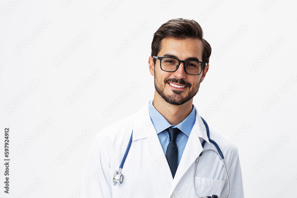 Male smile doctor in a white coat and eyeglasses and a stethoscope looks at the camera on a white isolated background, copy space, space for text, health