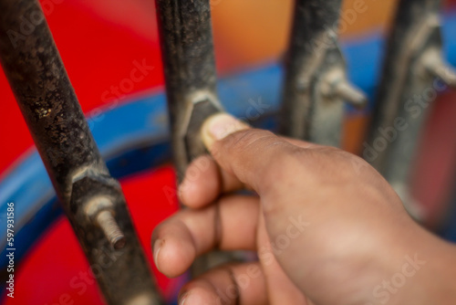 A hand holds an iron and the background is blurred