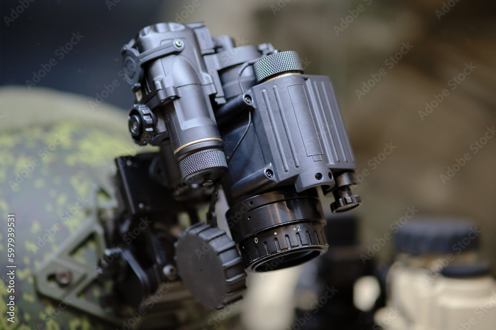 Army binoculars with night vision on a soldier's helmet. Optical device on a military helmet for tracking in war