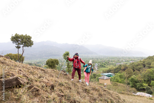 Happy couple trekking on a mountain. © G-images