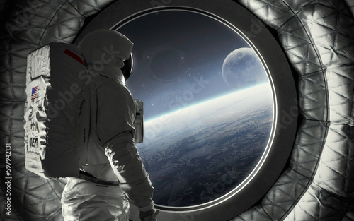 Fototapeta Naklejka Na Ścianę i Meble -  An astronaut stands at the huge window of a spaceship and looks at Earth and moon. 5K realistic science fiction art. Elements of image provided by Nasa