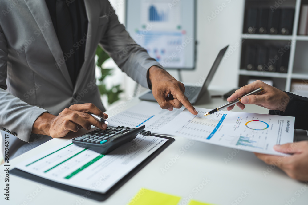 Businessman using calculator to calculate company financial statements with colleagues have an analysis Discuss documents and work together to solve problems within the company. Businessman using calculator to calculate company financial statements with colleagues have an analysis Discuss documents and work together to solve problems within the company.