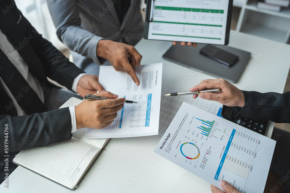 Businessman discussing with colleague plan analyzing financial data charts and graphs. sales strategy Calculate a numerical balance sheet from papers at successful meetings and teamwork.