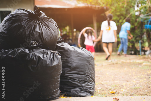The big black garbage bag placed on the floor.