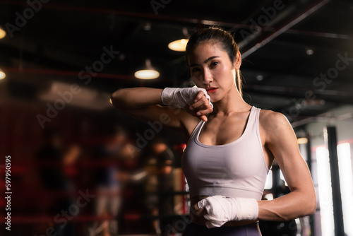 Beautiful female preparing bandages fighter trains in boxing  at gym. © kamonrat