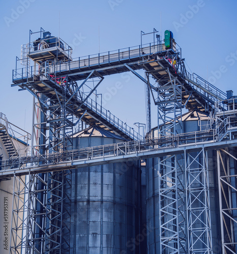 Modern silos for storing grain harvest at the blue sky background. 