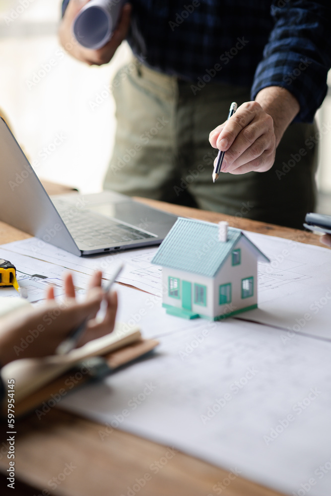 Fototapeta premium Architects and engineers are working together to edit the draft house plan that was designed after it was presented to the client and partially revised the design. Interior design and decoration ideas
