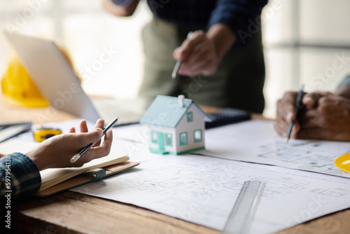 Architects and engineers are working together to edit the draft house plan that was designed after it was presented to the client and partially revised the design. Interior design and decoration ideas