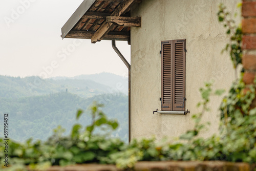 Panoramic view of the hills from an old house with wooden roof and window in San Sebastiano da Po Castle, Torino, Piemonte region, Italy