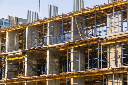 A frame made of load-bearing reinforced concrete walls during the construction of a multi-storey building. Reinforcement of reinforced concrete columns. Construction of high-rise buildings.