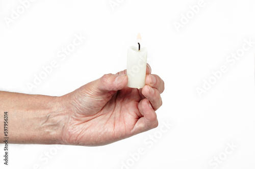Men's hand holding a candle isolated white background. Man holding burning candle, closeup