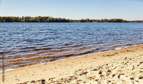 Fototapeta Naklejka Na Ścianę i Meble -  Water's edge on the shore. Wave of blue sea on sandy beach. Beautiful background with water ripples on the beach