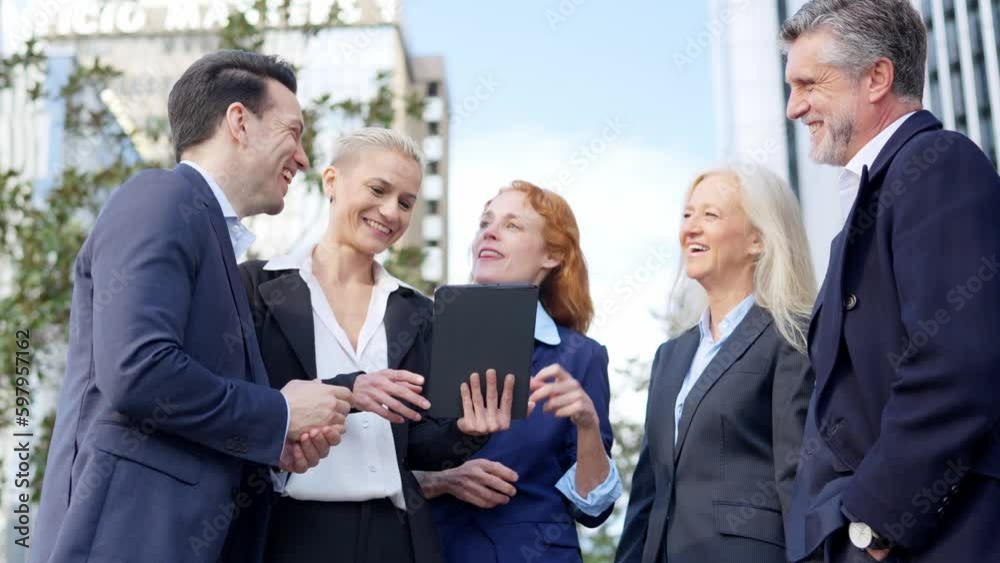 Business people laughing in a business meeting in the street Business people laughing in a business meeting in the street