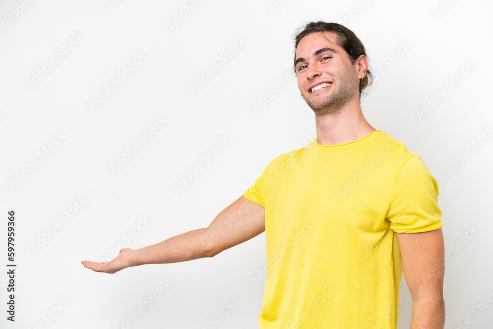 Caucasian handsome man isolated on white background extending hands to the side for inviting to come Caucasian handsome man isolated on white background extending hands to the side for inviting to come