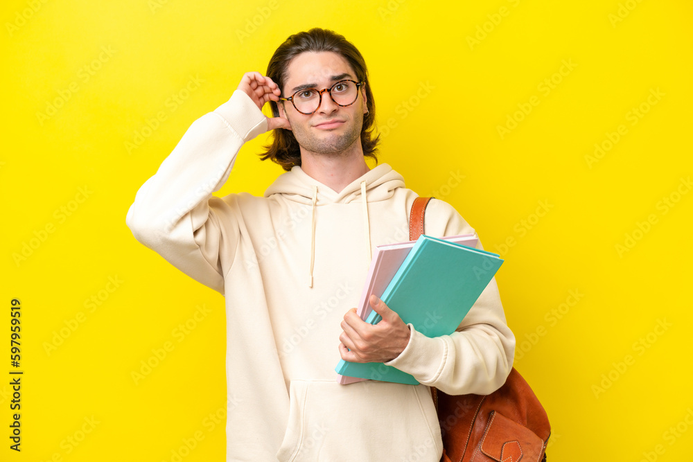 Young student handsome man isolated on yellow background having doubts Young student handsome man isolated on yellow background having doubts