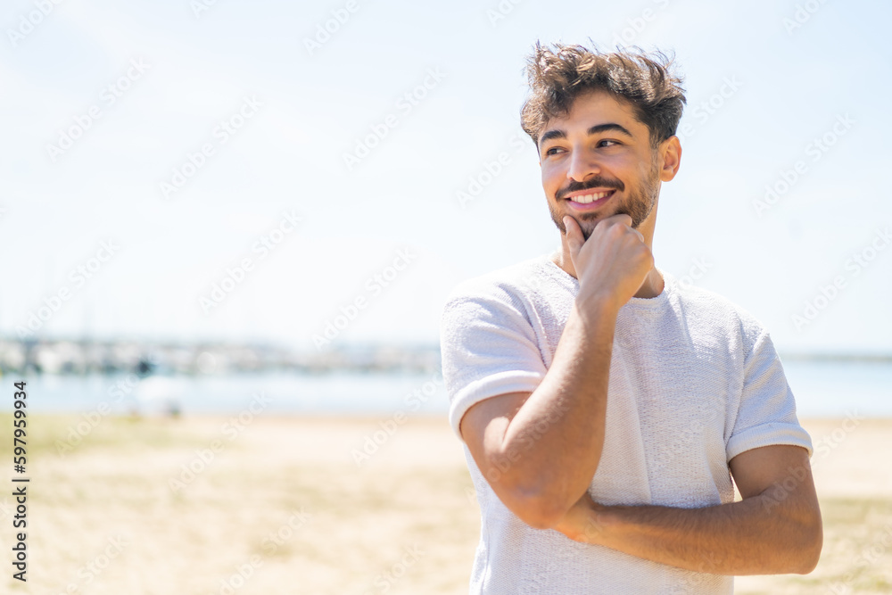 © luismolinero - Handsome Arab man at outdoors looking to the side © luismolinero - Handsome Arab man at outdoors looking to the side
