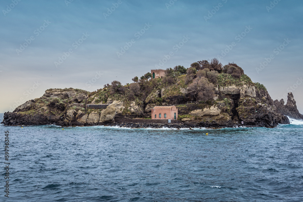 One of islets of Cyclopean Isles seen from shore of Aci Trezza township on Sicily Island, Italy
