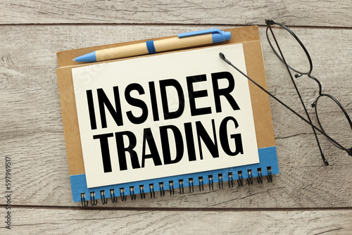фотографія insider trading a blank sheet of paper on a notepad near the glasses