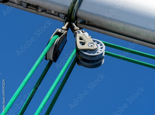 A buoyant hoist installed on the yacht that is tied with a green rope attached to the sail.