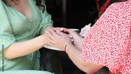 Hands of two women who hold each other's hands and support in  conversation. 4K Resolution