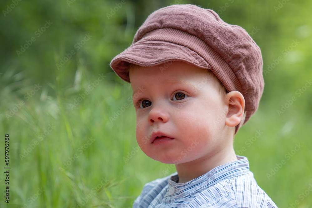 Portrait of a handsome and happy little boy enjoying a sunny summer day in a nature park. The concept of active recreation for children and the joy of being in nature. Portrait of a handsome and happy little boy enjoying a sunny summer day in a nature park. The concept of active recreation for children and the joy of being in nature.