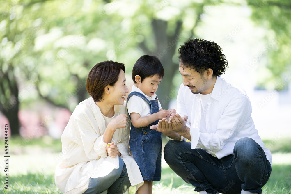 Family relaxing with children in a fresh green park Sit down Family relaxing with children in a fresh green park Sit down