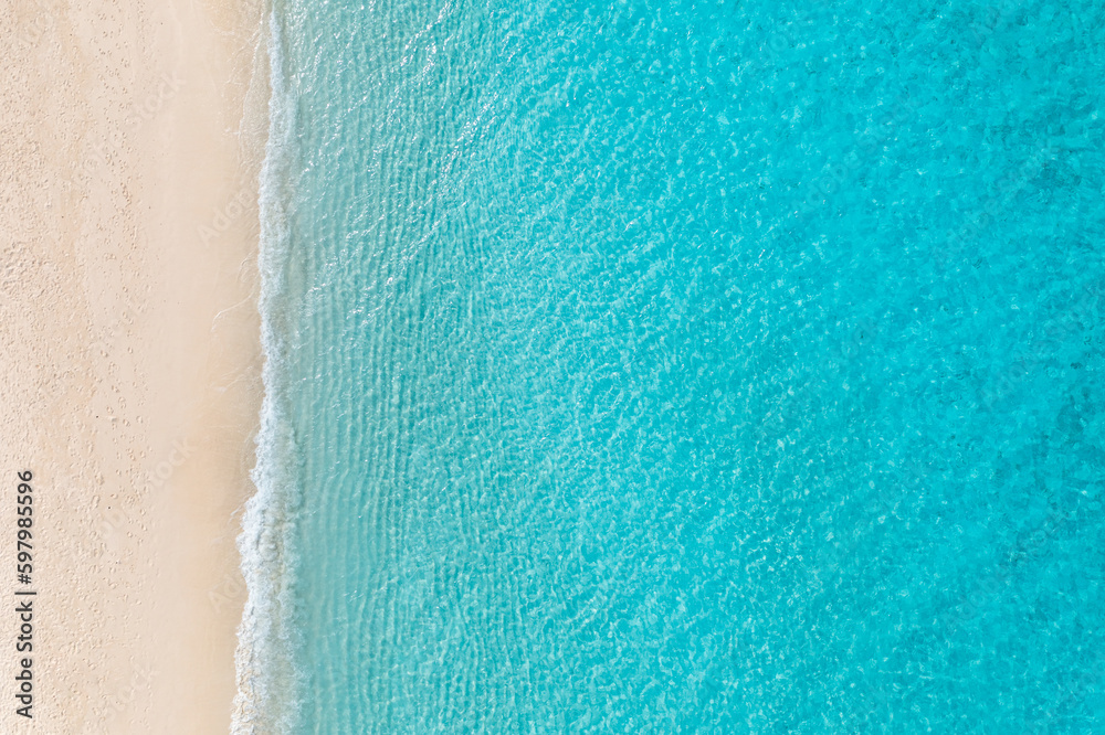 Summer seascape beautiful waves, blue sea water in sunny day. Top view from drone. Relax sea aerial view amazing tropical nature background. Tranquil bright sea waves splashing beach sand sunset light - obrazy, fototapety, plakaty 