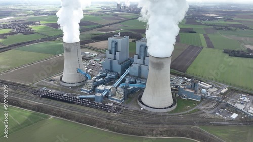 Aerial drone video of a brown coal power plant in Germany, capturing the magnitude of the industrial infrastructure and surrounding landscape. photo