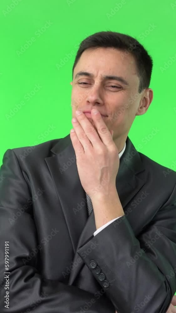 Dreamy man in elegant suit touching chin Dreamy man in elegant suit touching chin