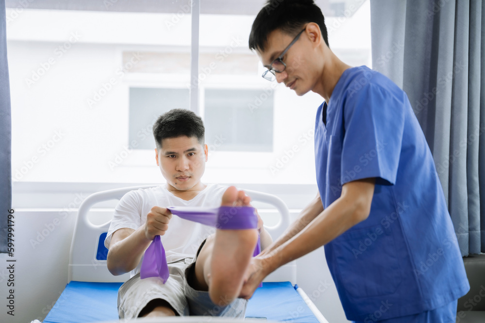 Patient at the physiotherapy doing physical exercises with therapist. Patient at the physiotherapy doing physical exercises with therapist.