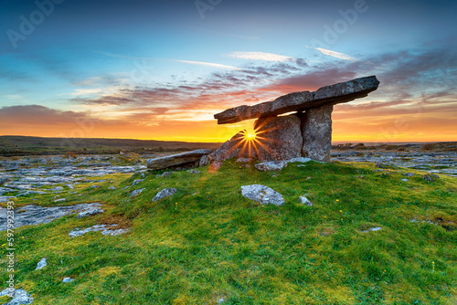 Sunset over Poulnabrone dolmen an ancient portal tomb in the Burren photo