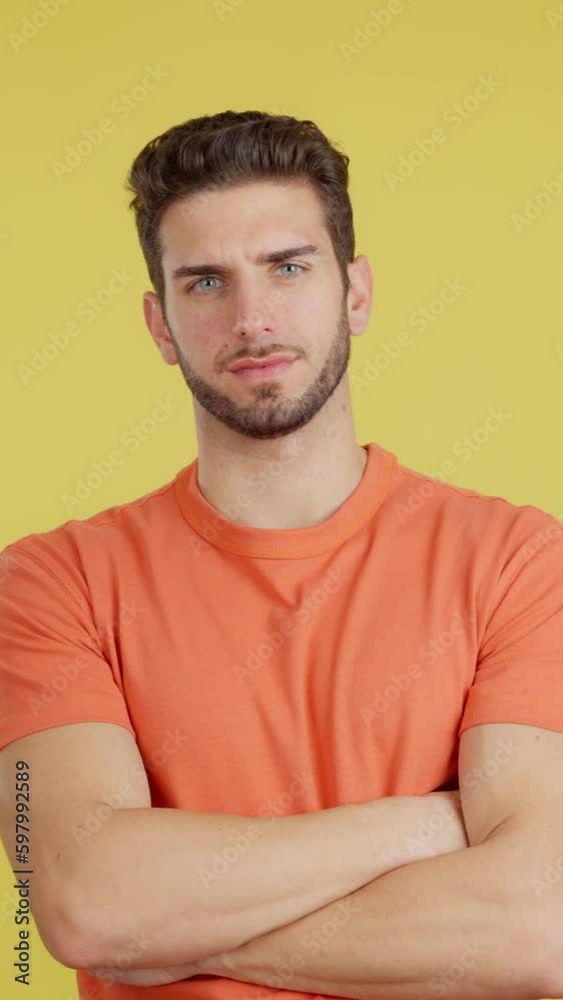 Serious man standing with arms crossed looking at camera Serious man standing with arms crossed looking at camera