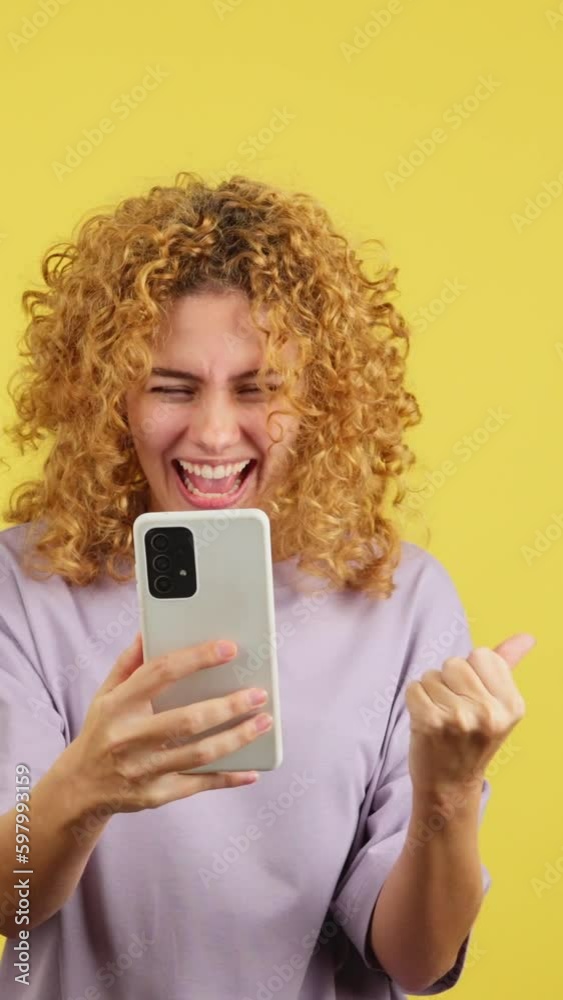 Excited woman celebrating while using the mobile phone Excited woman celebrating while using the mobile phone