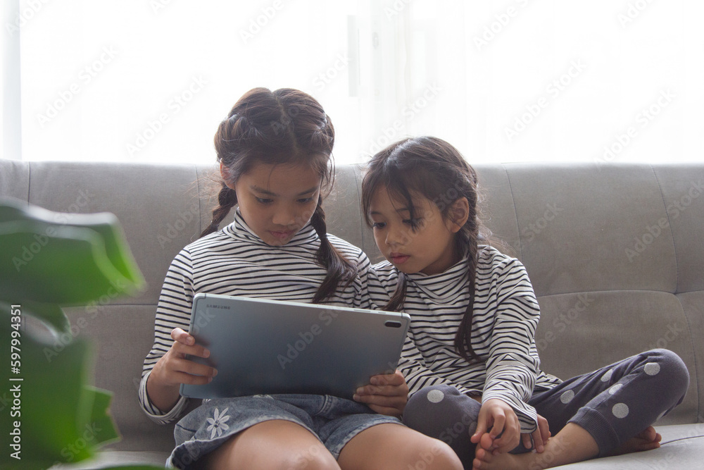 Fototapeta premium Education, elementary school, learning, technology and people concept - group of school kids with tablet pc computer having fun