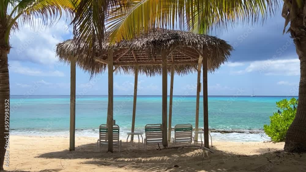 A view of Cemetery Beach through a cabana on Seven Mile Beach in Grand Cayman Island A view of Cemetery Beach through a cabana on Seven Mile Beach in Grand Cayman Island