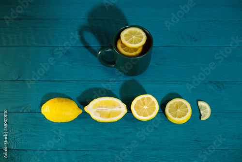 fresh, juicy lemons with a beautiful cup on a blue background